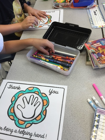 children using felt markers to do thank you placemats